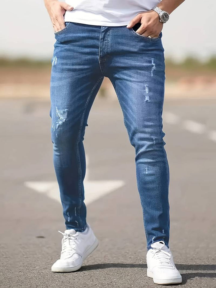 Herrjeans i modern, slim fit med trasiga detaljer och stretchig komfort i svart