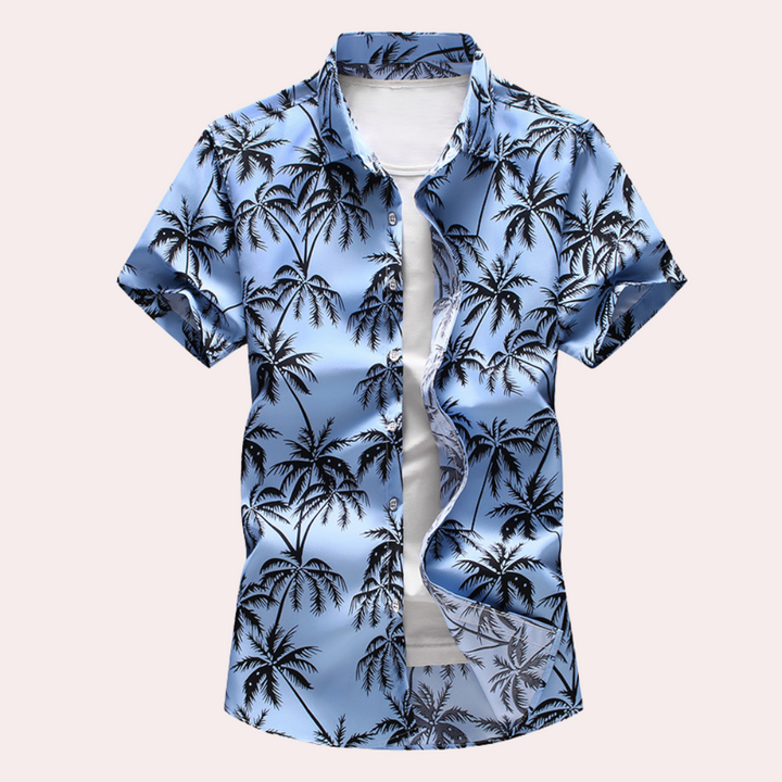 Mönstrad hawaiiansk herrskjorta med blommor, perfekt för sommar, strand och avslappnade fester. Kortärmad, sval.