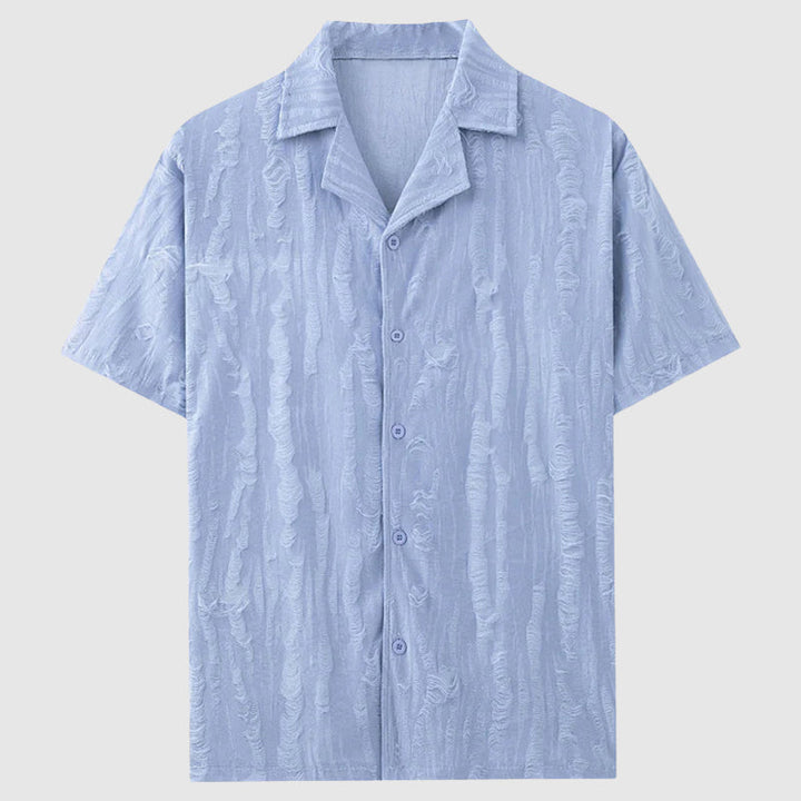 Avslappnad herrskjorta Pioltello med snyggt vågmönster. Blå/vit kortärmad för en stilren sommarlook.