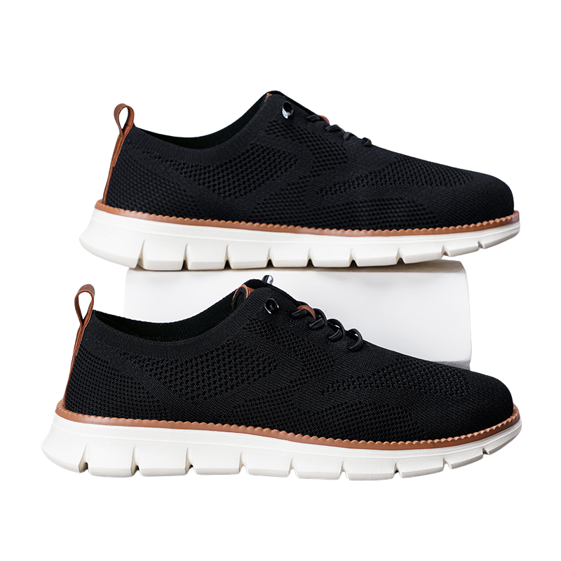 Andningsbara herr sneakers i grå med mörk sula, fotograferade från sidan. Ideal för casual stil och vardagsbruk.