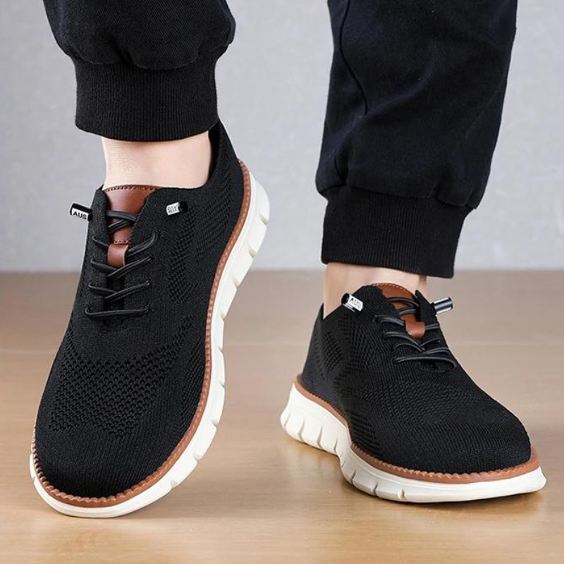 Herrskor: Svart, andningsbar casual sneaker i mesh med vit EVA-sula, detaljbild av sulans komfort.