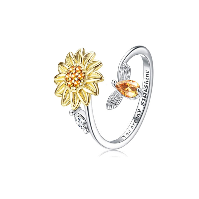 Justerbar damring i sterling silver med snurrande solros, perfekt som ångestring för stresslindring.