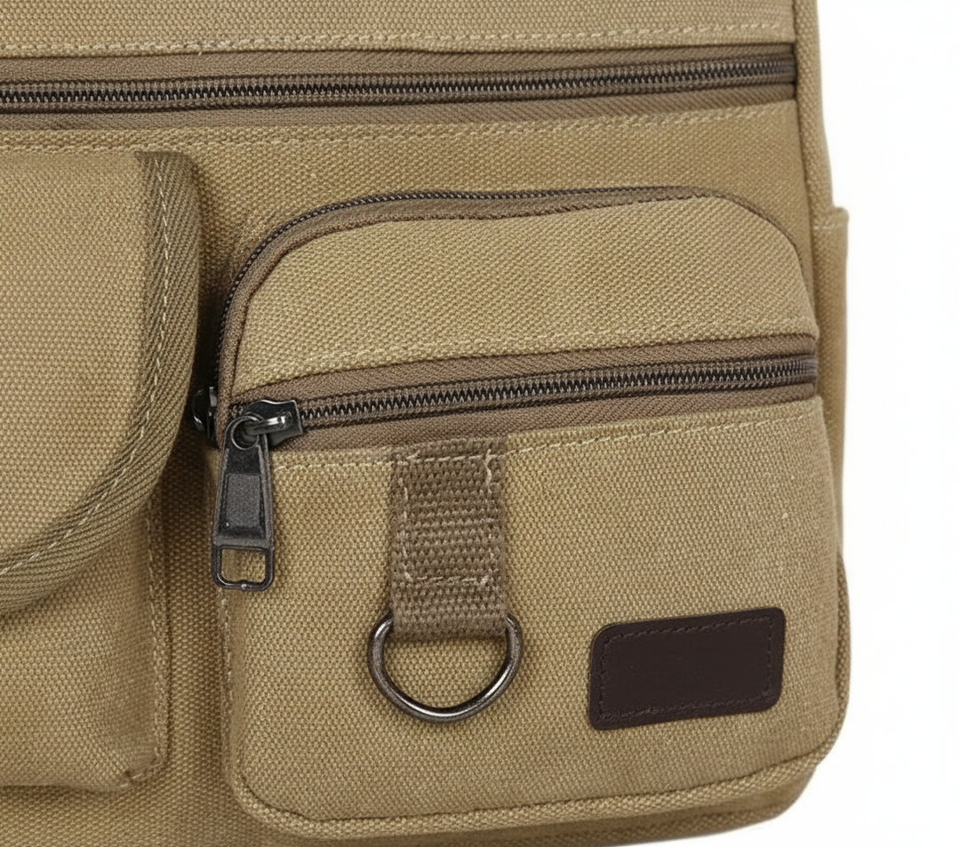 Hållbar vintage-inspirerad canvas axelväska i khaki, utmärkt som arbetsväska, skolväska eller vardagsväska.