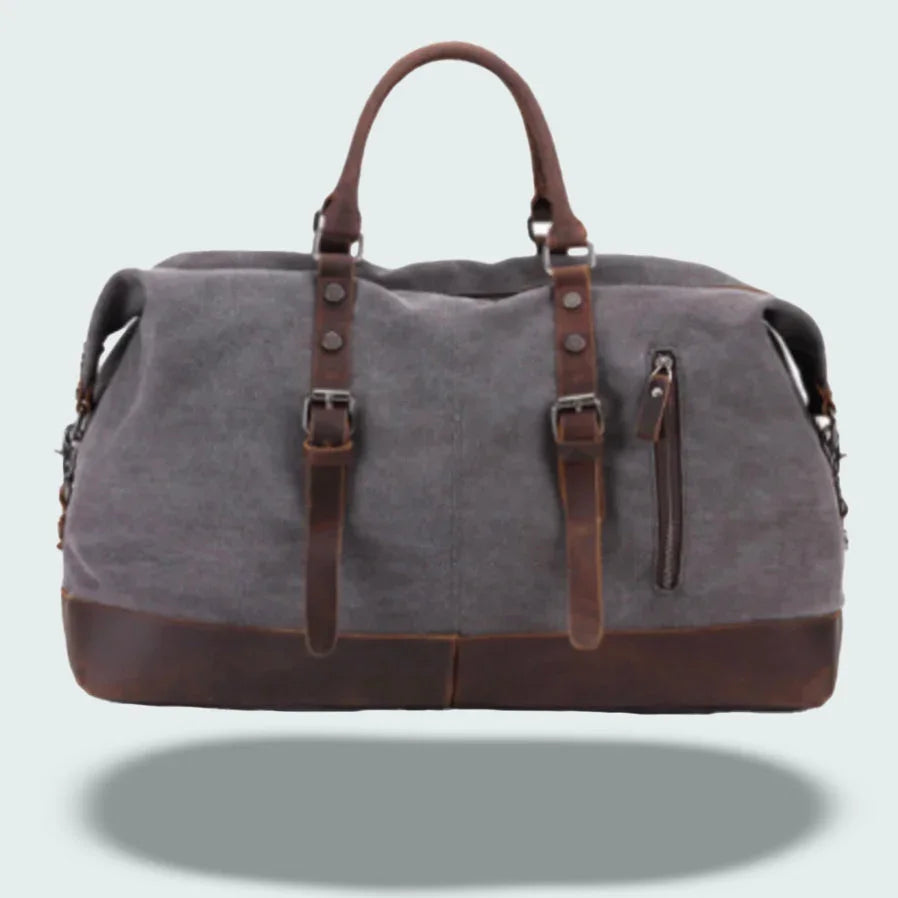 Robust canvas duffelväska med eleganta läderdetaljer, idealisk som weekendväska för herr.