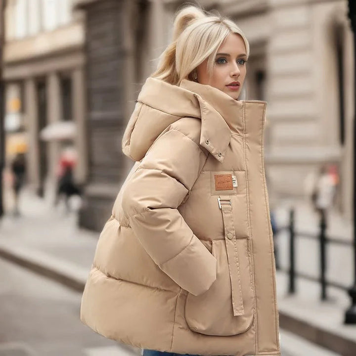 Elegant lång damjacka i klassisk stil. Varmt ytterplagg av polyester-bomull för vinter och höst.