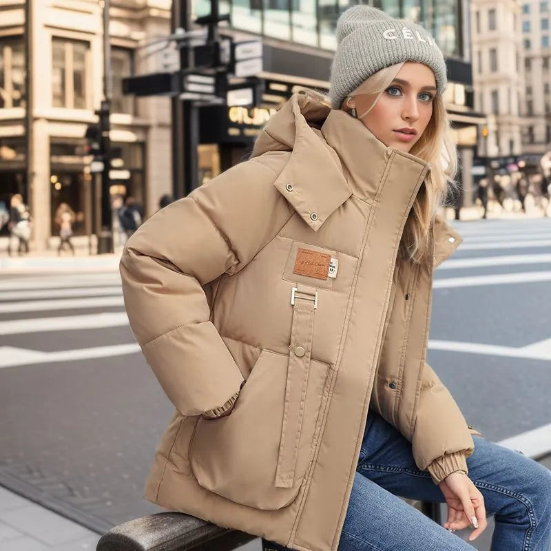 Lång damvinterjacka i klassisk design. Varmt ytterplagg av polyester-bomull för höst och vinter. Elegant & bekväm.