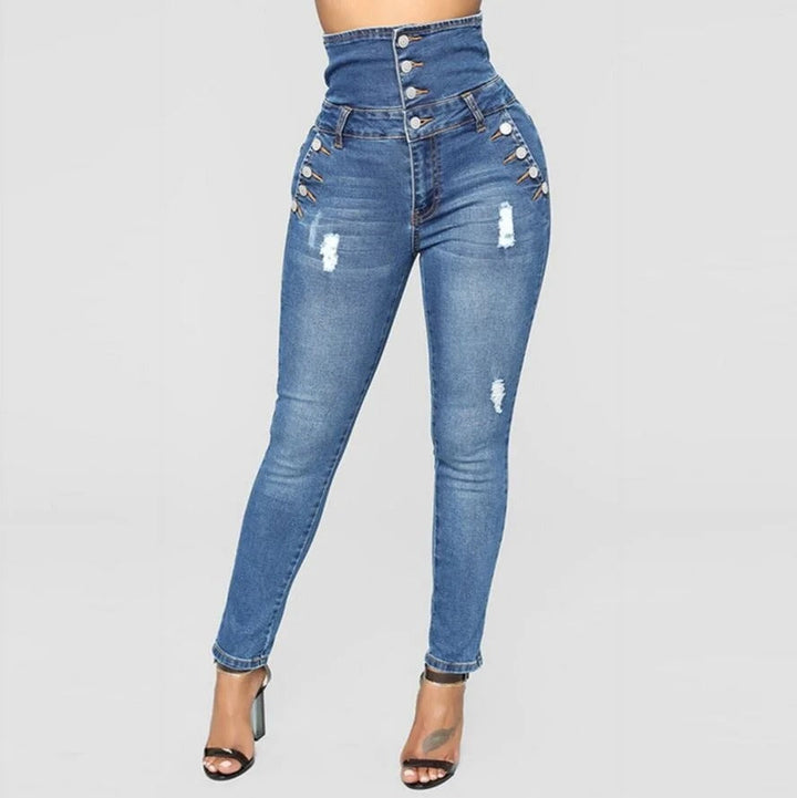 Närbild av stretchigt denimmaterial på kvinnors högmidjade jeans i slim fit