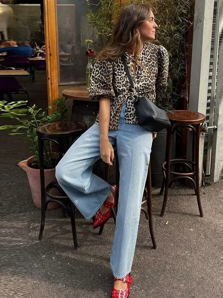 Mångsidig kvinnors leopardblus med chic puffärm och peplum. En trendig festtopp eller vardagslook.