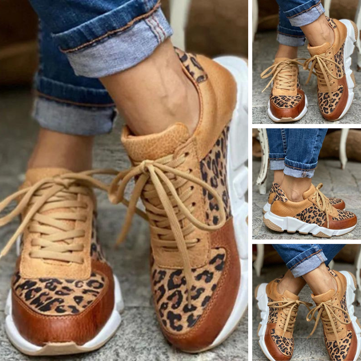 Detaljbild av trendiga kvinnors leopard chunky sneakers, snörskor med djurmönster och tjock sula.