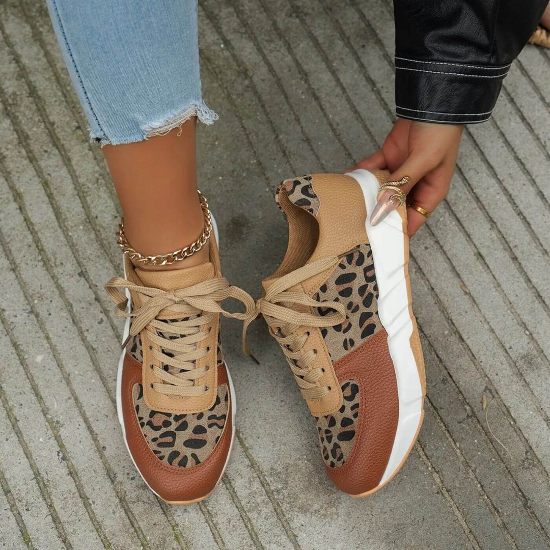 Närbild på kvinnors leopardmönstrade sneakers. Trendiga festskor med detaljerat mönster för en stilsäker look.