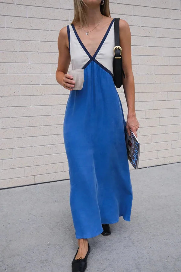Kvinnors V-ringad midi klänning. Elegant färgblocksmönster för en stilren look, perfekt som festklänning.