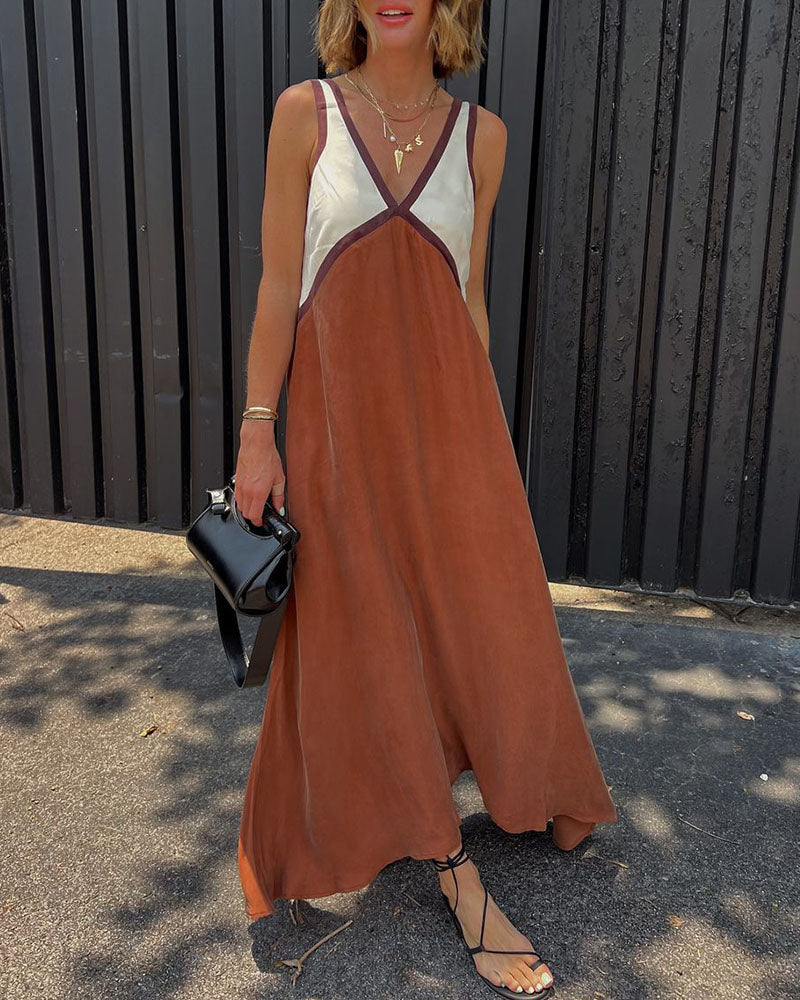 Kvinnors V-ringad festklänning i midi-längd med trendigt färgblock. Elegant och bekväm modeklänning.