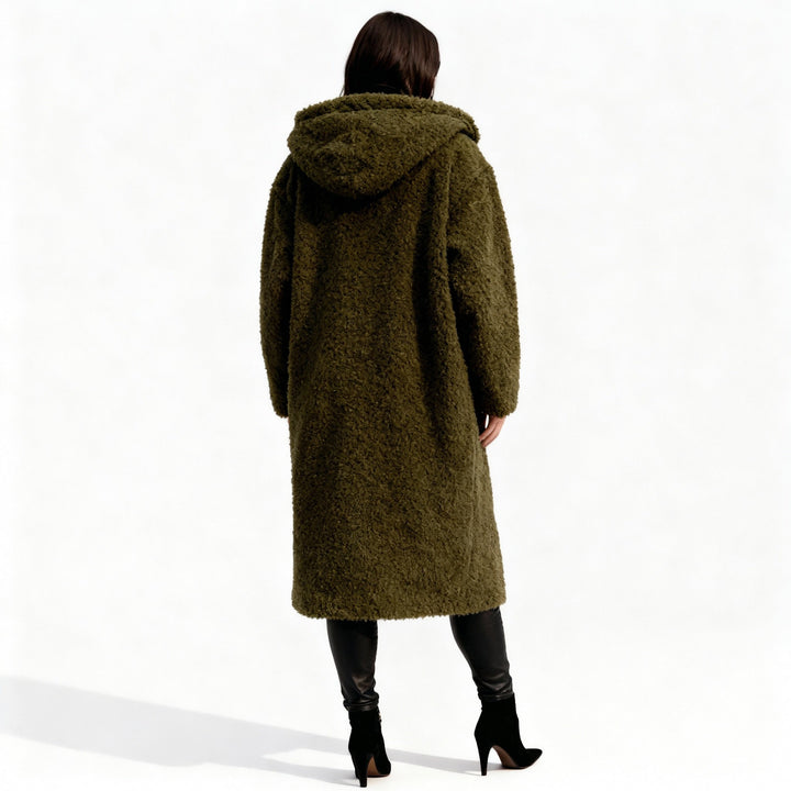 Kvinnors långkappa med huva sedd bakifrån, med avslappnad passform. Varm vinterjacka i modern street style.