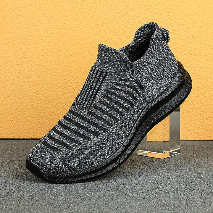 Närbild av ventilerande mesh på lätta herrskor, bekväma slipons för sommarbruk utomhus.
