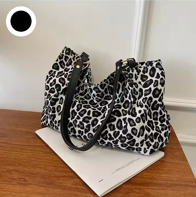 Robusta handtag på leopardmönstrad tygväska. Ergonomisk och praktisk axelväska.