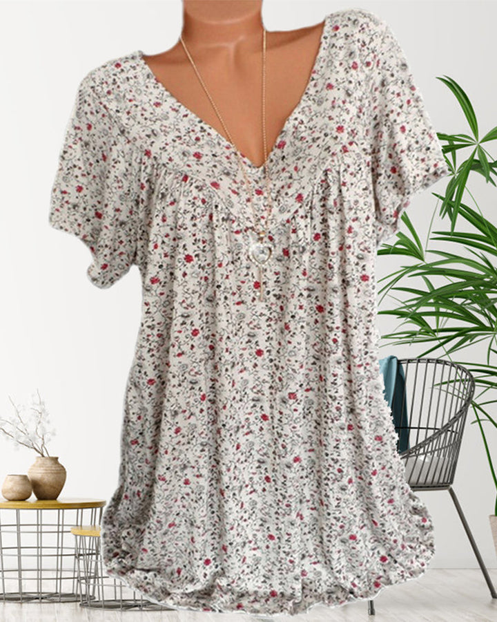 Elegant vit kortärmad blus med V-ringning för kvinnor, tillverkad i ett lätt material, passar till vardag och fest.