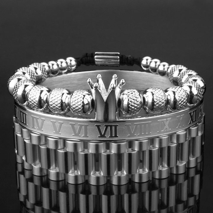 Glänsande krona armband set för herr i stål med zirkoner, perfekt för en kunglig look.