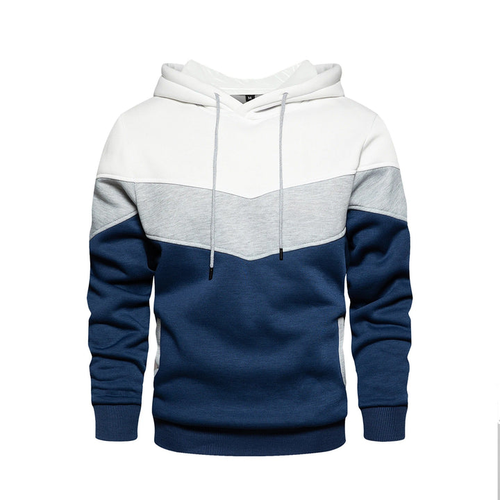 Man bär grå/svart herr patchwork hoodie. Avslappnad streetwear för komfort och stil.