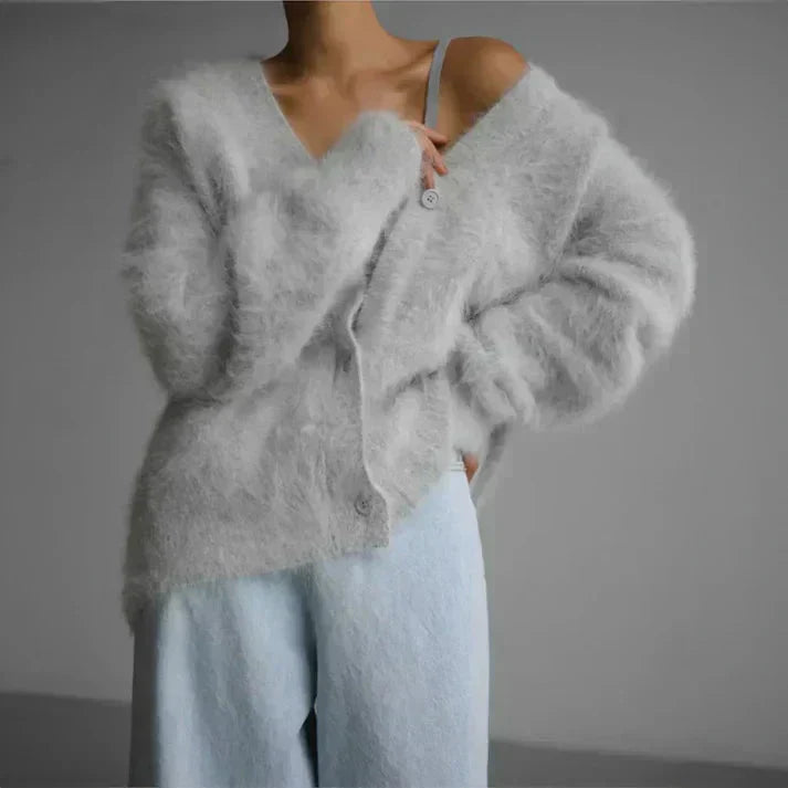 Enfärgad stickad damväst med knappar. Varm, elegant och bekväm för höstens och vinterns outfits.