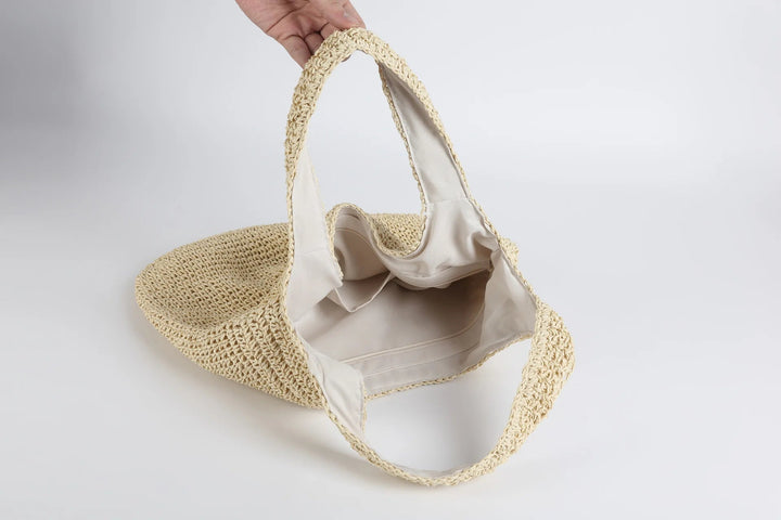 Dam toteväska i solkysst design, brun/beige färg, en praktisk modeväska för stranden.