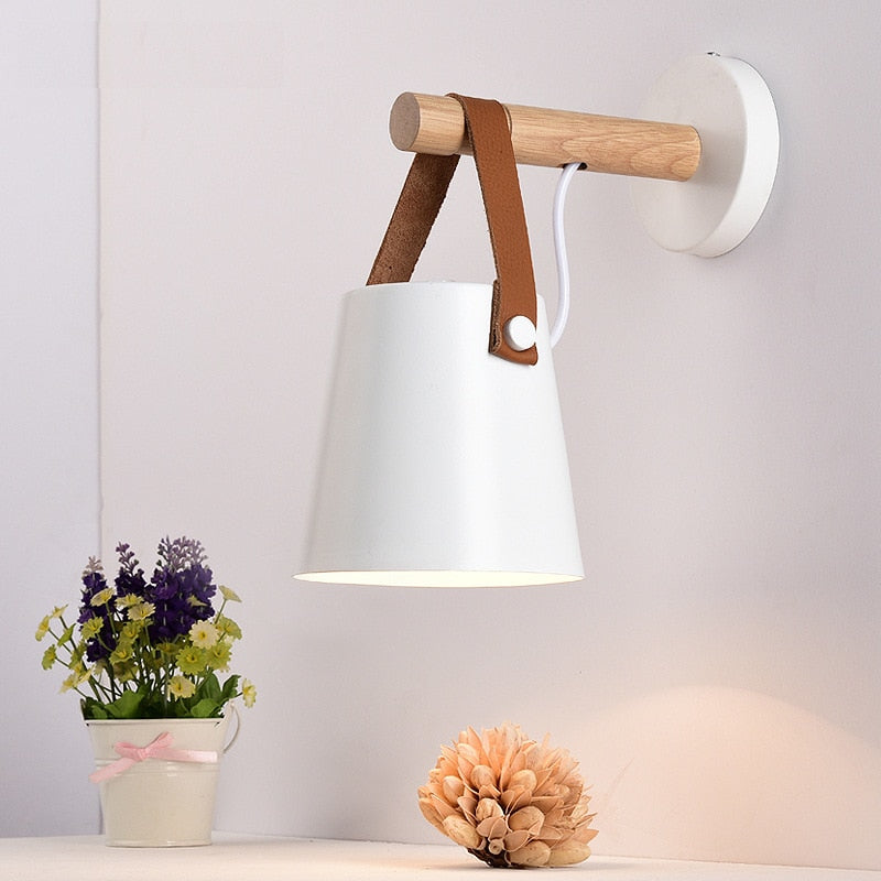 Skandinavisk vägglampa av trä och svart metall, stilren belysning för sovrum och vardagsrum.