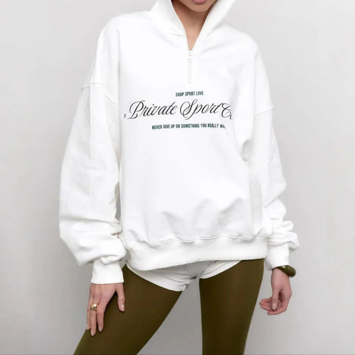 Oversized damtröja med halv dragkedja och trendigt bokstavstryck. Bekväm sweatshirt för vardags- & höstmode.