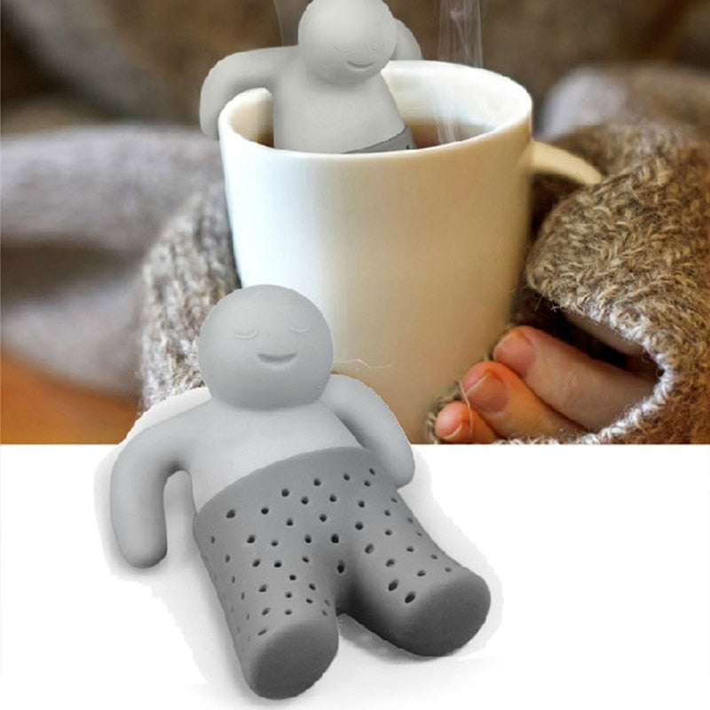 Grön teinfuser av silikon, formad som en leende person, för en rolig fikastund.