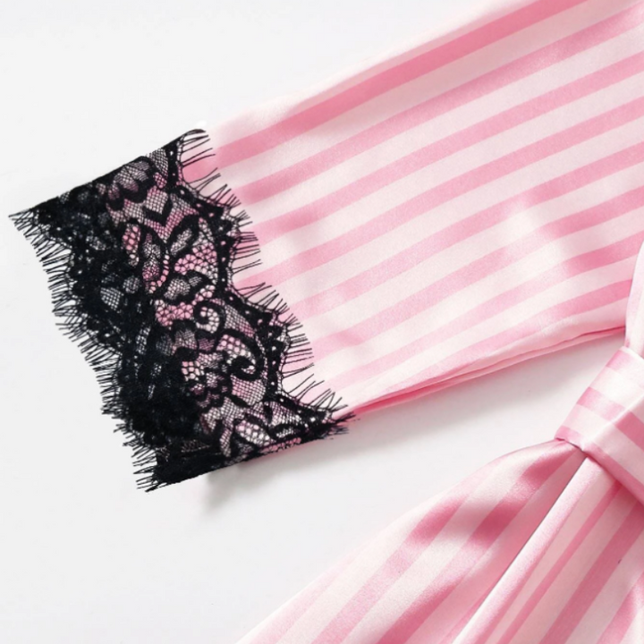 Detaljerad bild av ett rosa 4-delat nattklädeset i satin. Lyxiga och mjuka sovkläder för kvinnor.