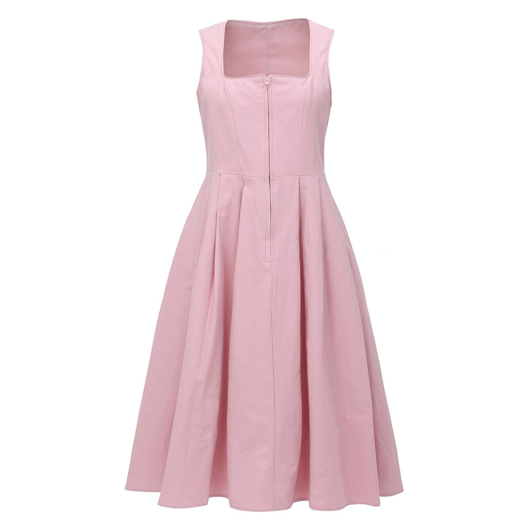 Kvinnlig modell i en vacker rosa dirndl festklänning, redo för Oktoberfest firande.