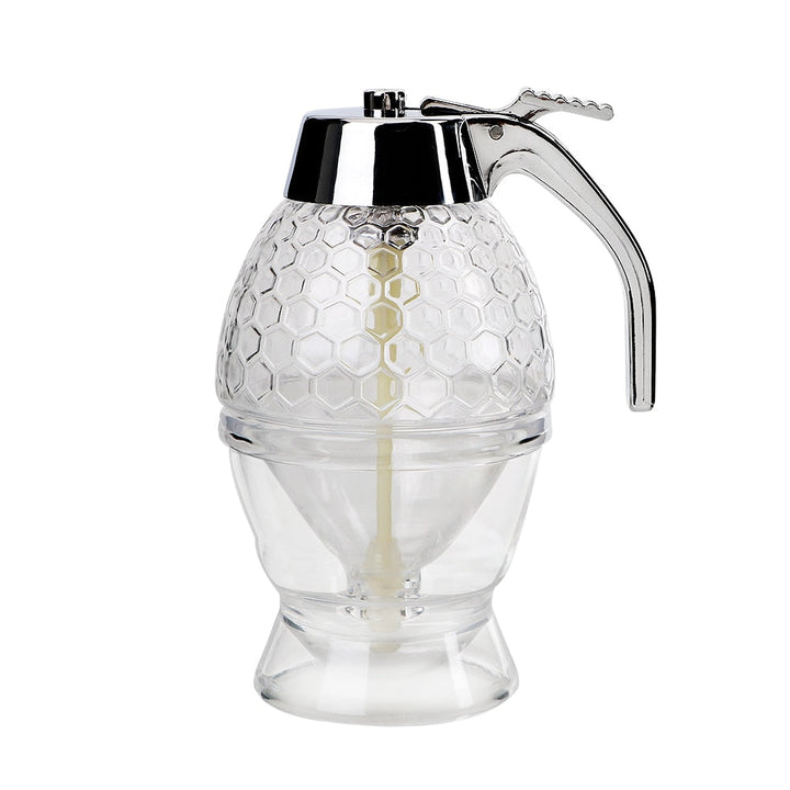 Droppfri sirapsdispenser i glas och plast, ett praktiskt serveringsredskap för frukostbordet.