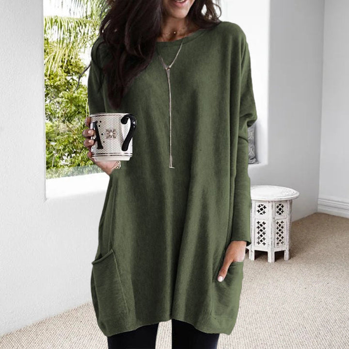 Modell bär modern dam pullover med fickor, visar stilfull design och bekväm passform.
