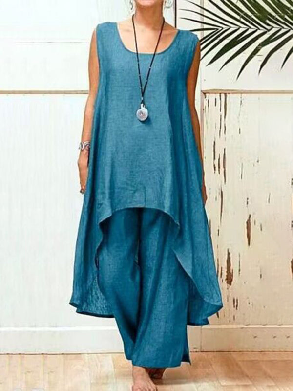 Trendig dam byxdress med ärmlös design, oregelbunden silhuett och vida ben för en stilren look under våren/sommaren.