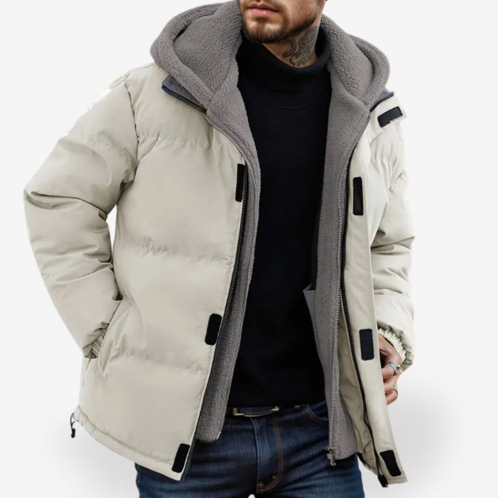 Detaljbild av herr hoodie jackans väderbeständiga tyg & mjuka insida. Idealisk isolering för utomhusaktiviteter.
