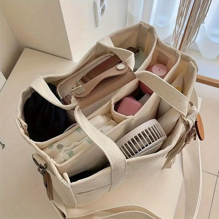 Elegant beige unisex bärkasse, perfekt vardagsväska. Mångsidig accessoar för stilmedveten organisering.