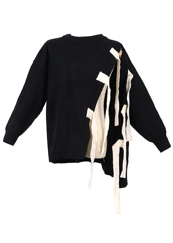Modern svart damtröja med asymmetrisk patchwork. Lös passform, bekväm och trendig för höstvardag.