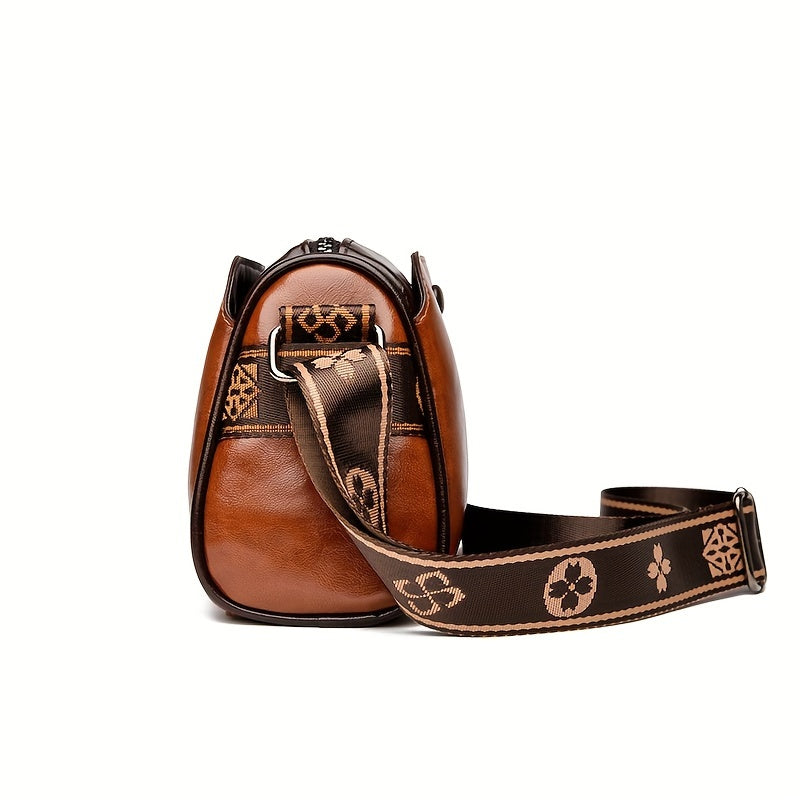 Kompakt svart damväska med justerbar crossbody-rem. Funktionell och elegant för alla tillfällen.