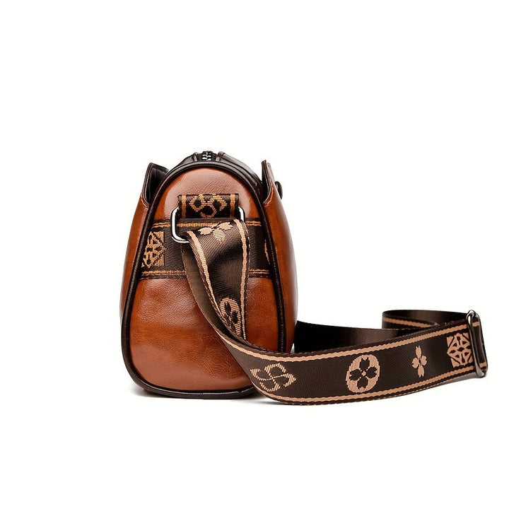 Kompakt svart damväska med justerbar crossbody-rem. Funktionell och elegant för alla tillfällen.