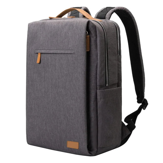 Grå laptopryggsäck unisex med integrerad USB-port. Organiserad design, idealisk för stadsliv, skola och jobb.
