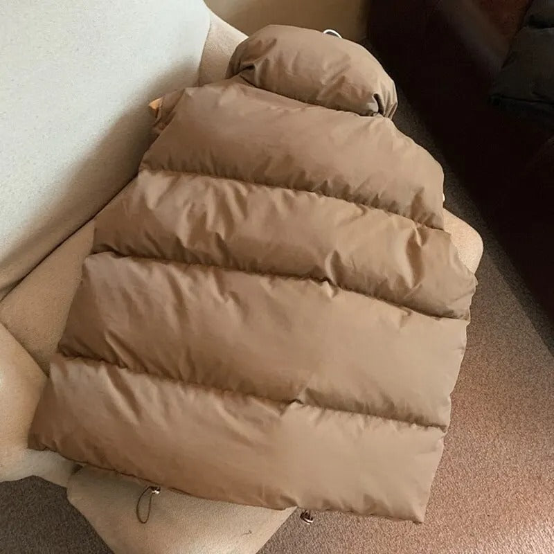 Stilren vinterväst för kvinnor, varm dunväst i mörkblått med hög krage.