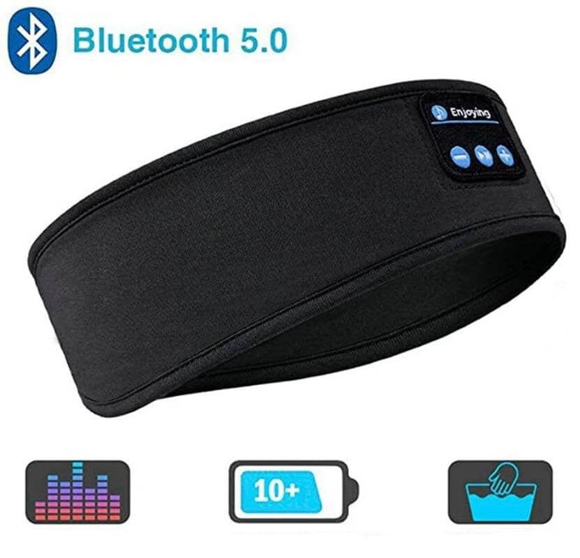 Trådlöst Bluetooth sportpannband på ett bord, bredvid en smartphone, redo för anslutning och ljud.