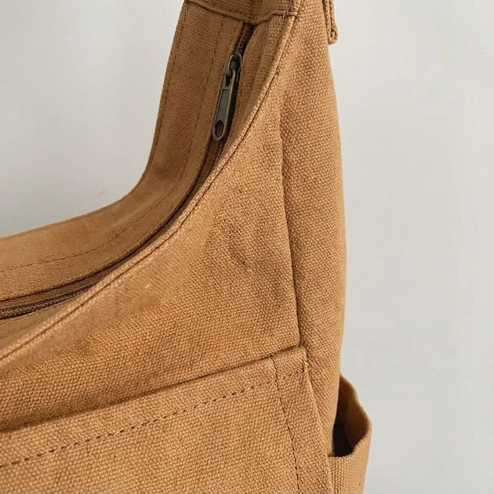 Organiserad canvas messengerväska. Praktisk unisex crossbody med flera fack, perfekt som stilren vardagsväska.