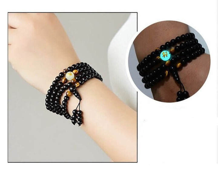 Herrsmycke: Kraftfullt drakarmband i svart obsidian. Symboliserar skydd och andlig styrka och energi.