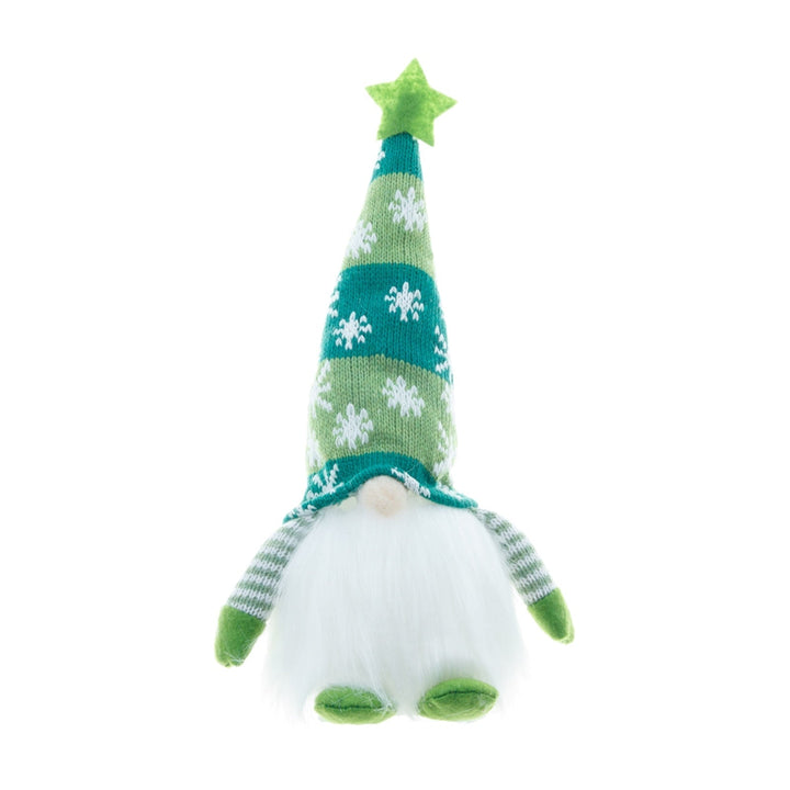 Dekorativ upplyst jultomte stående vid en gran. Skapar festlig juldekoration.