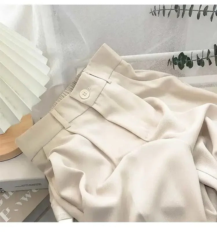 Ankelbyxor för kvinnor med hög midja och raka ben, tillverkade i mjuk polyester.