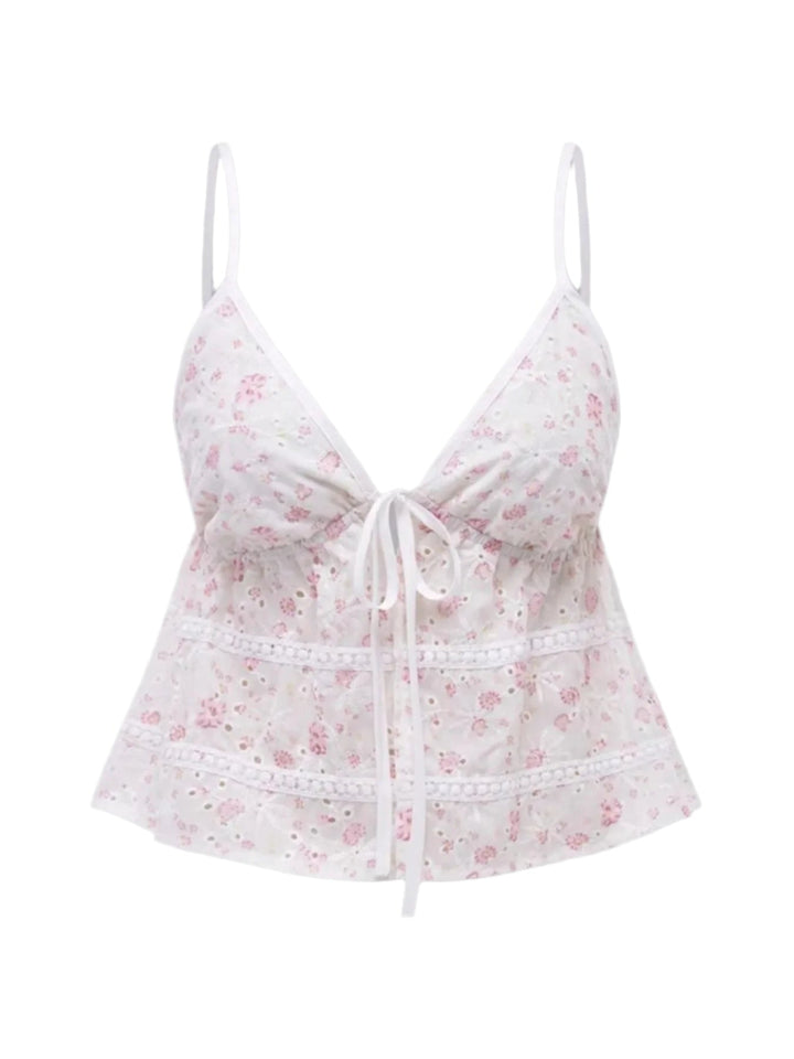 Vit blommig cami topp för kvinnor med elegant knytning fram. Perfekt ärmlöst linne för sommar och semester.